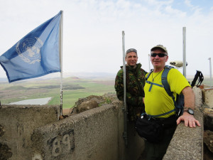 Schechter with a UN observer and the United Nations Flag looking into Syria.