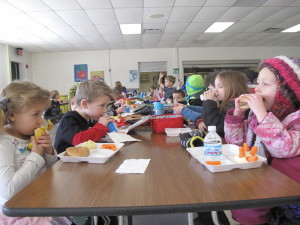 Leah Pratt and Owen Rochester, kindergarteners at Harvey Swanson Elementary, eat their lunch last week. Under the recently introduced H.R. 610, nutritional standards passed for school meals in 2012 would be repealed. Photo by Susan Bromley. 