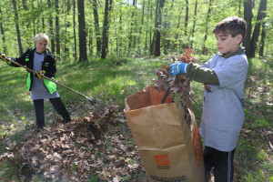 Dylon Carr 8 Bear cub and Ethan McLauchlin 9 Bear cub from pack 531 are cleaning from up a yard for Rockin and raking in Ortonville. May 2017